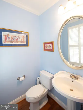 a white toilet sitting next to a bathroom sink