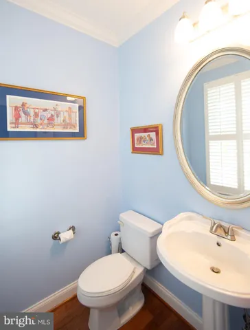 a white toilet sitting next to a bathroom sink