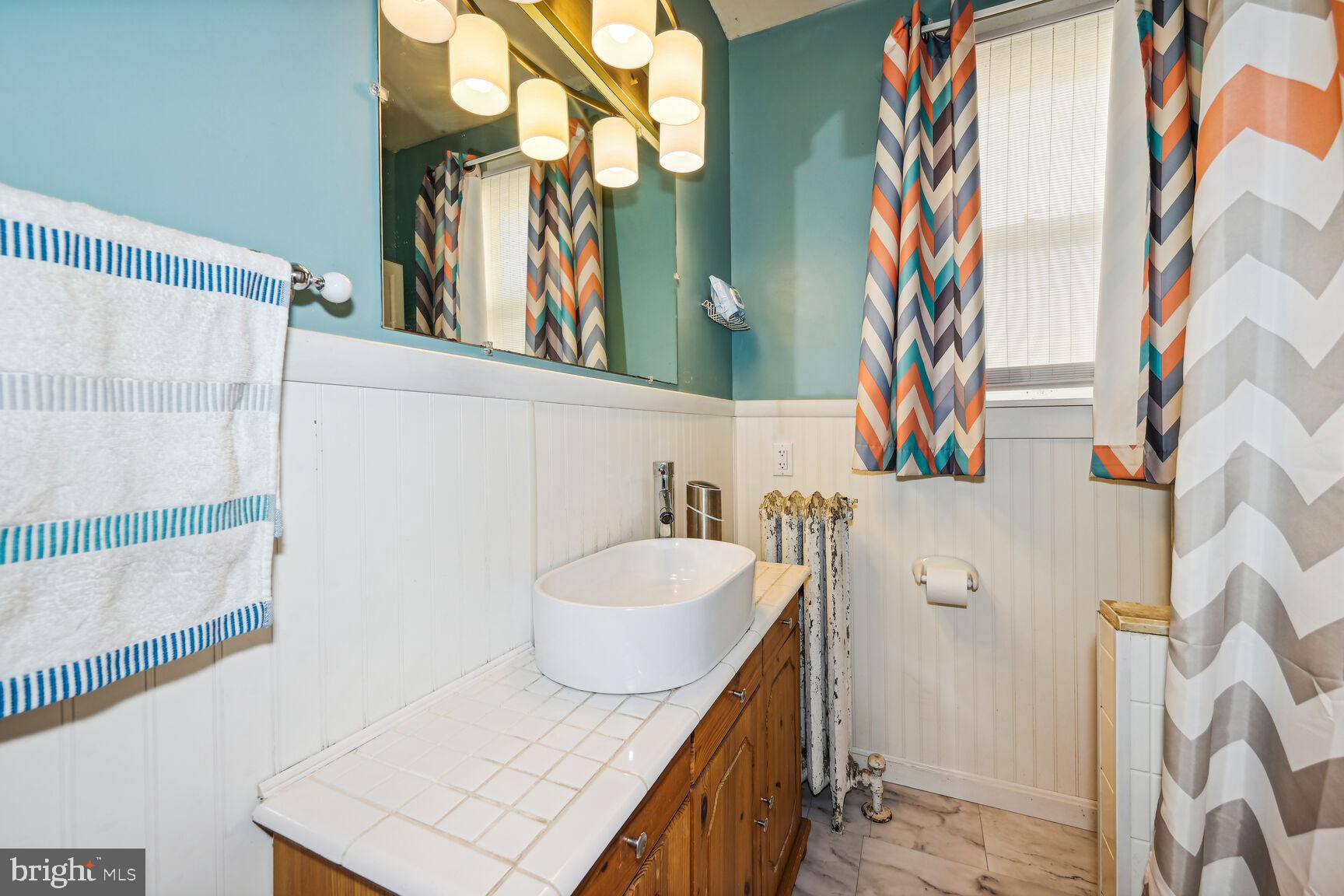 48 Haverford Road Runnemede, NJ 08078 - Photo 8 of 23 a bathroom with a sink and a mirror