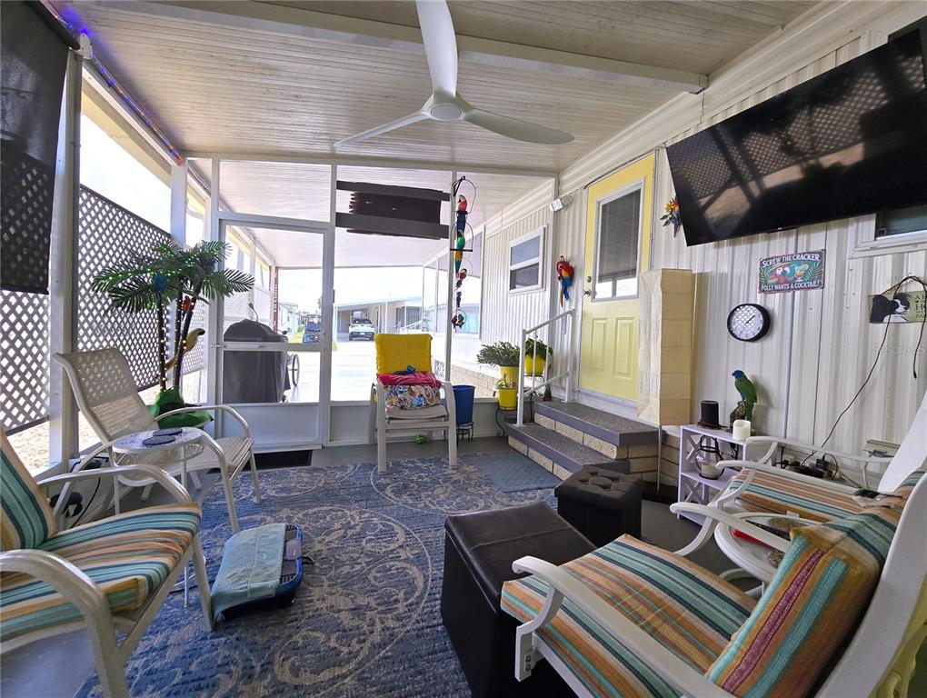 5619 Bayshore Road, Unit 435 Palmetto, FL 34221 - Photo 5 of 56 a living room with furniture and a flat screen tv