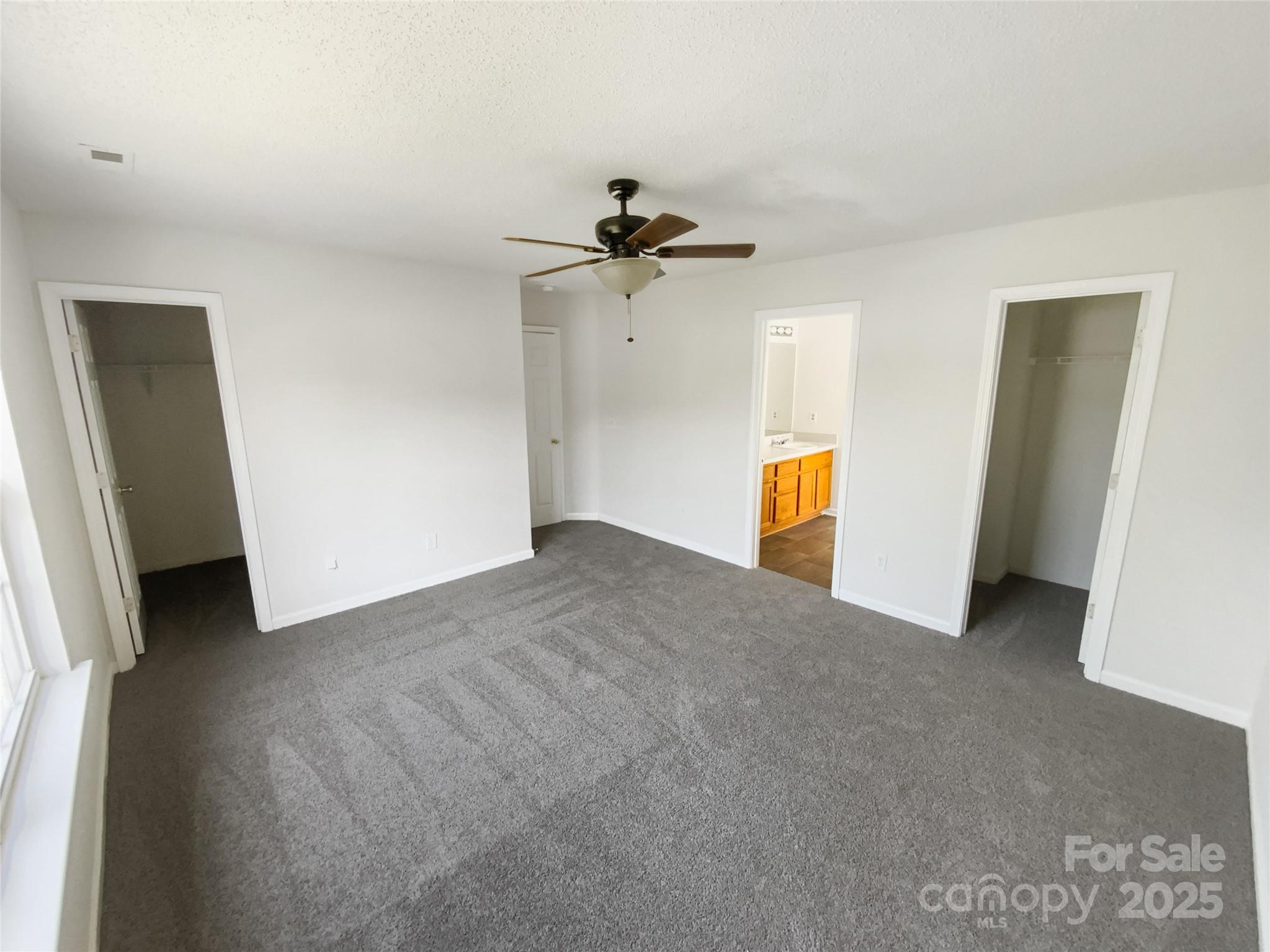 4437 Devonhill Lane Charlotte, NC 28269 - Photo 14 of 18 a view of a room with a ceiling fan and hardwood floor