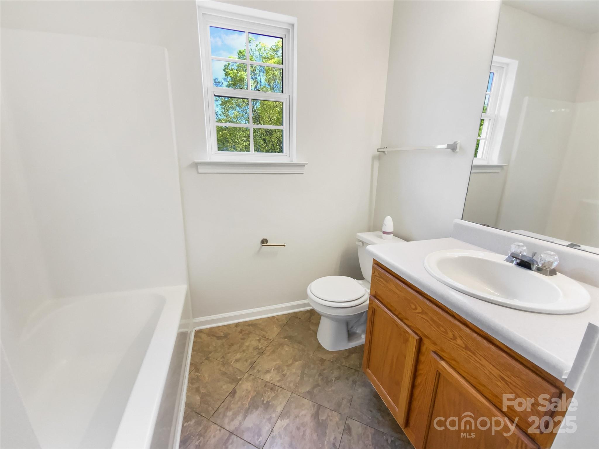 4437 Devonhill Lane Charlotte, NC 28269 - Photo 16 of 18 a bathroom with a sink and a toilet