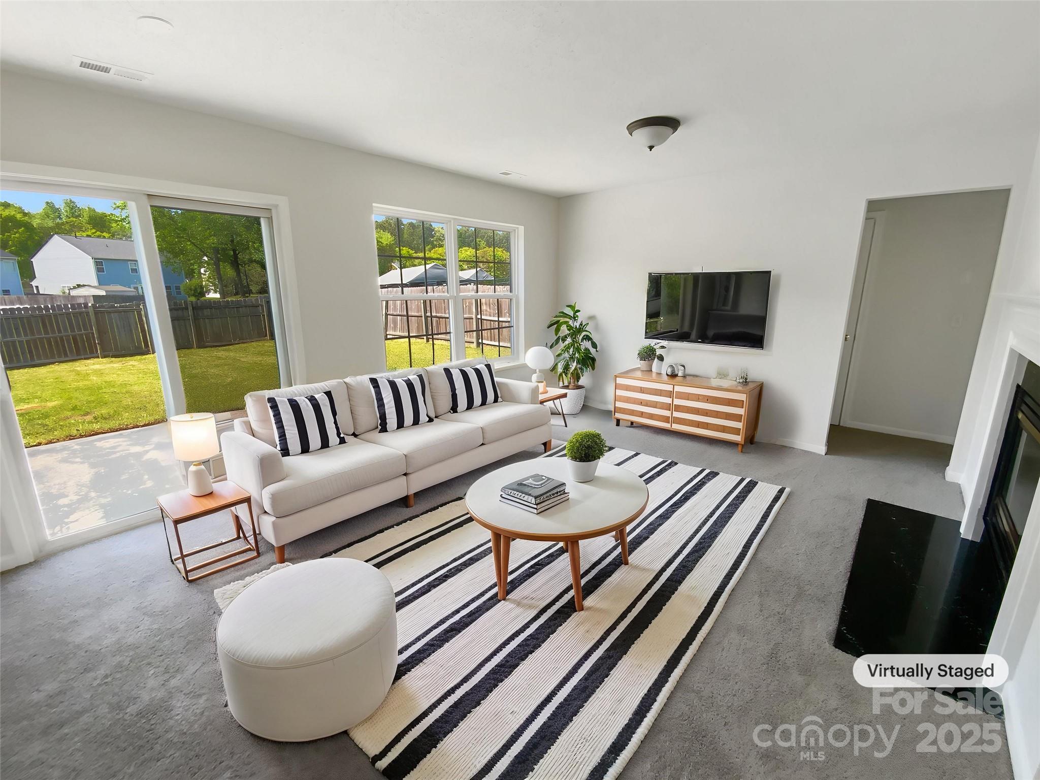 4437 Devonhill Lane Charlotte, NC 28269 - Photo 2 of 18 a living room with furniture and a flat screen tv