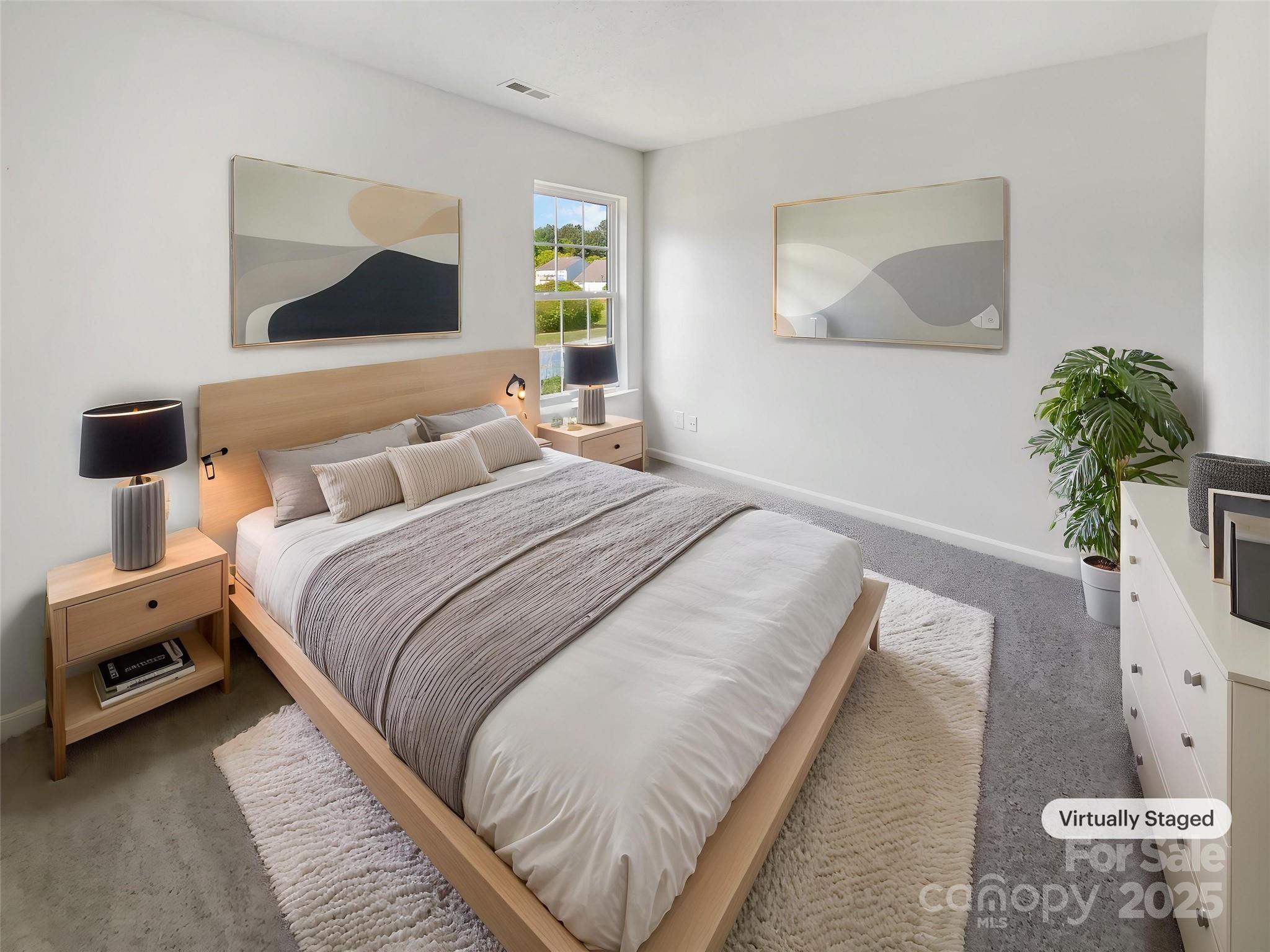 4437 Devonhill Lane Charlotte, NC 28269 - Photo 4 of 18 a bedroom with a bed and a painting on the wall