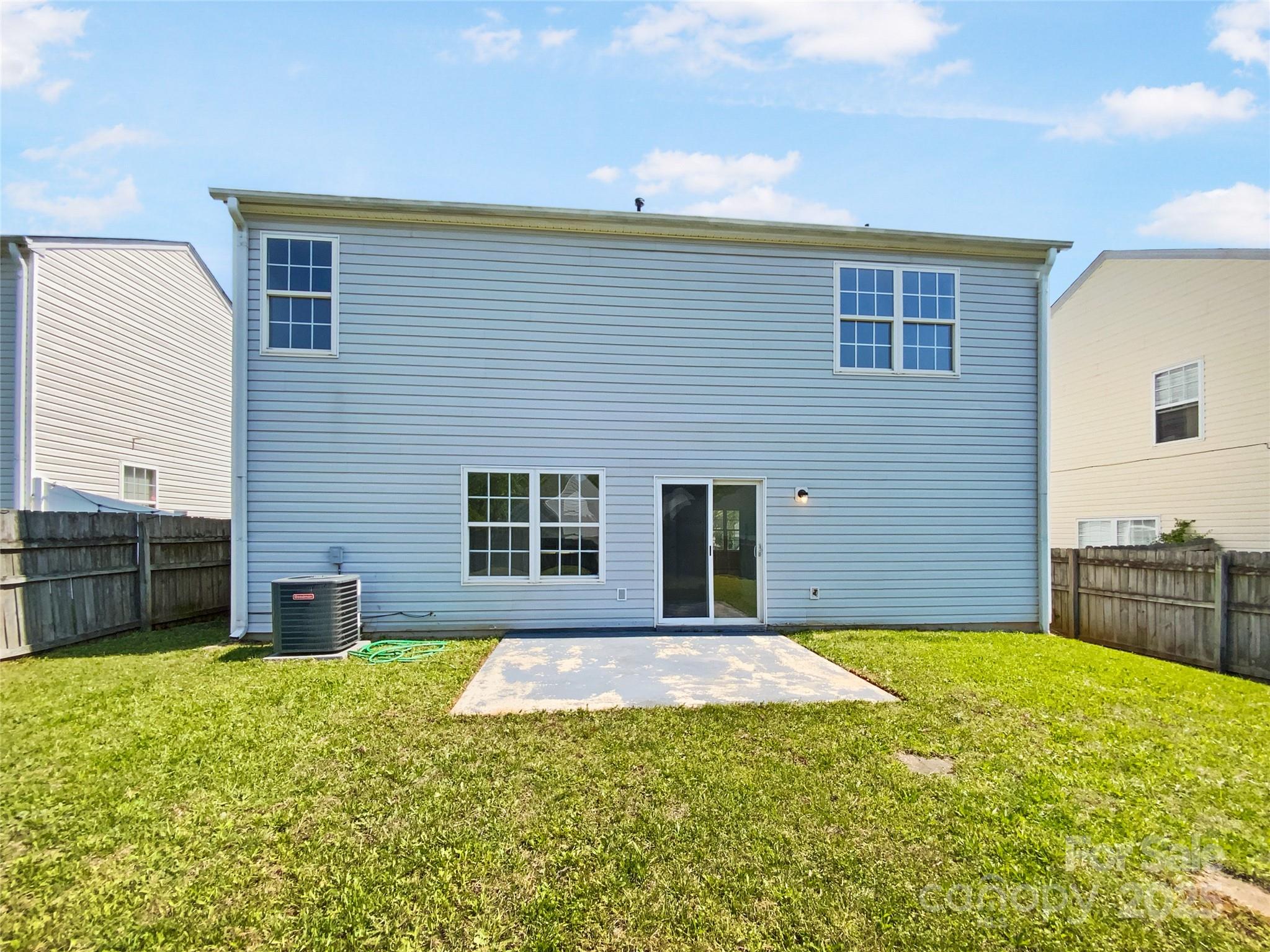 4437 Devonhill Lane Charlotte, NC 28269 - Photo 8 of 18 a view of a house with a backyard and a table and chairs