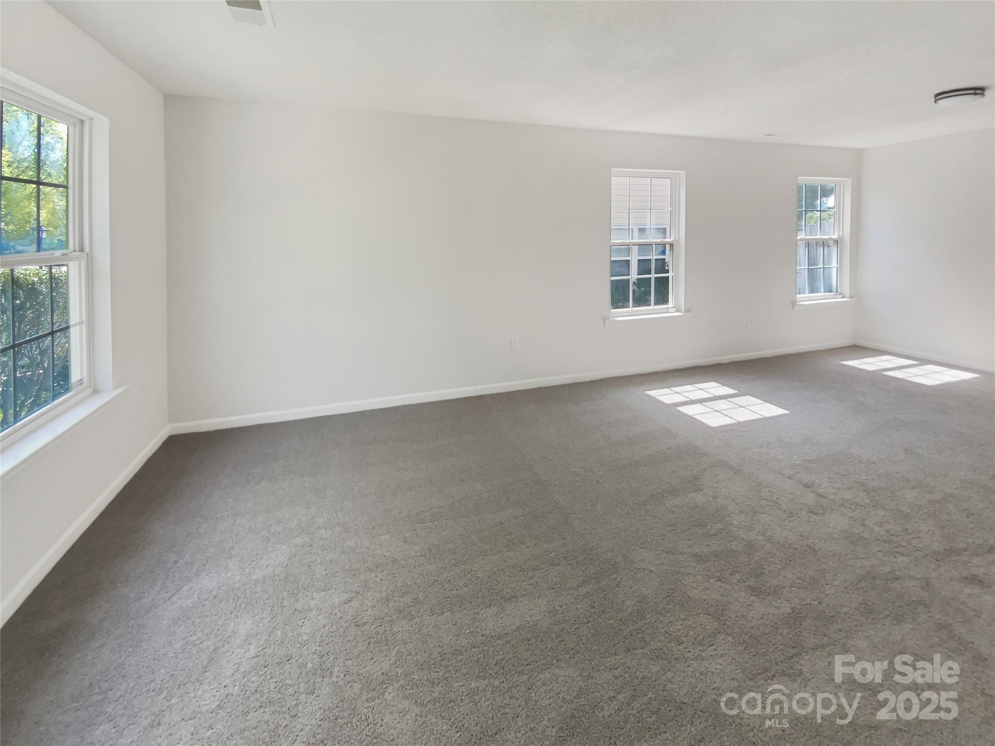 4437 Devonhill Lane Charlotte, NC 28269 - Photo 9 of 18 an empty room with windows