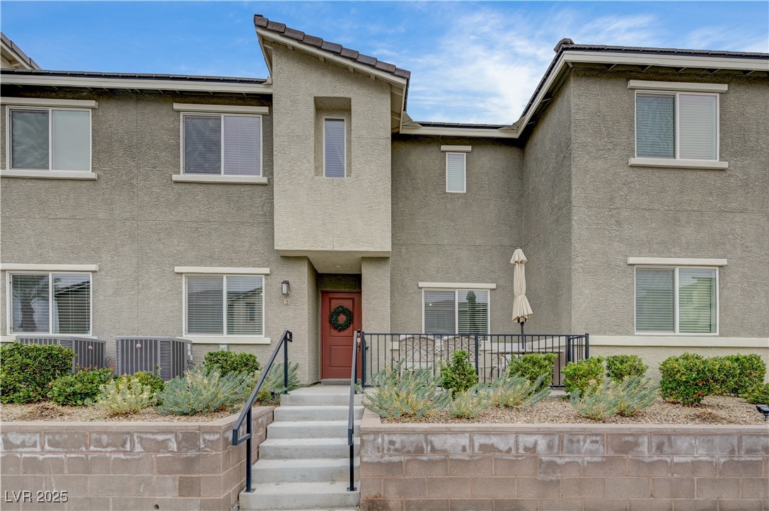 Traditional home featuring stucco siding