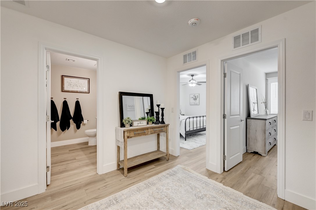 12106 Azure Gate Road, Unit 3 Las Vegas, NV 89183 - Photo 28 of 77 Hall featuring light wood-style flooring and baseboards