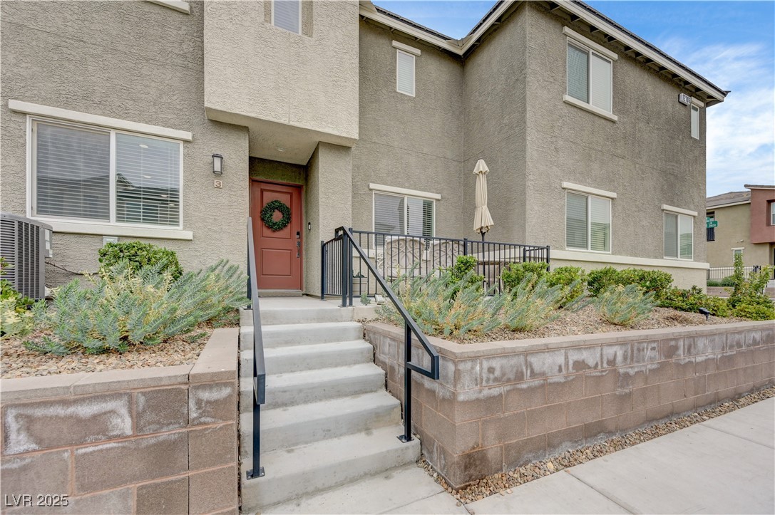 Property entrance featuring stucco siding
