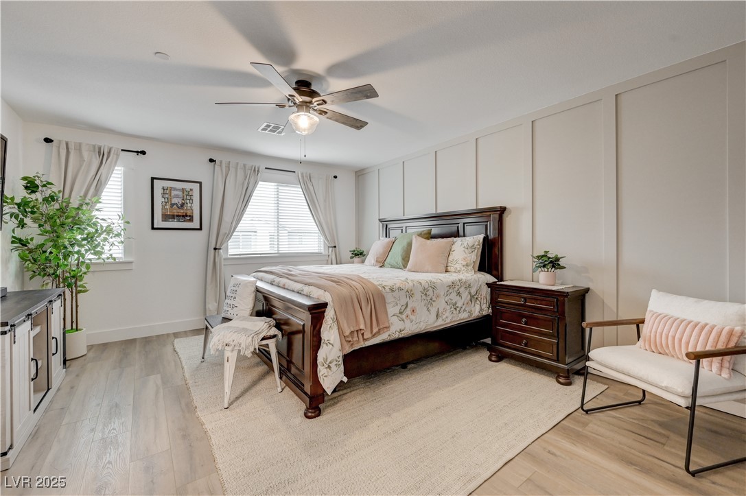 12106 Azure Gate Road, Unit 3 Las Vegas, NV 89183 - Photo 31 of 77 Bedroom with a decorative wall, light wood-style flooring, and ceiling fan