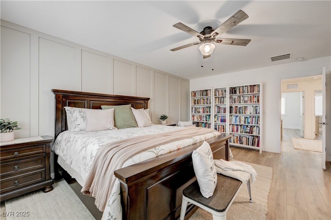 12106 Azure Gate Road, Unit 3 Las Vegas, NV 89183 - Photo 32 of 77 Bedroom featuring a decorative wall, light wood-style flooring, and a ceiling fan