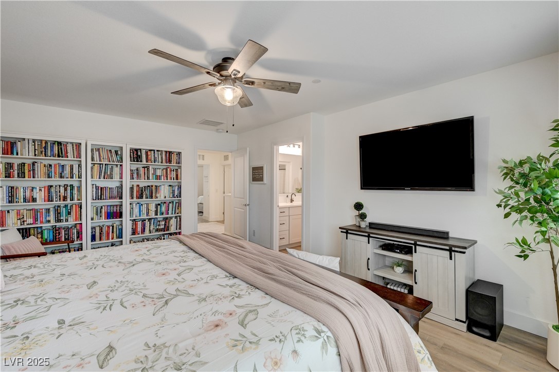 12106 Azure Gate Road, Unit 3 Las Vegas, NV 89183 - Photo 33 of 77 Bedroom with ceiling fan, connected bathroom, and light wood-style flooring