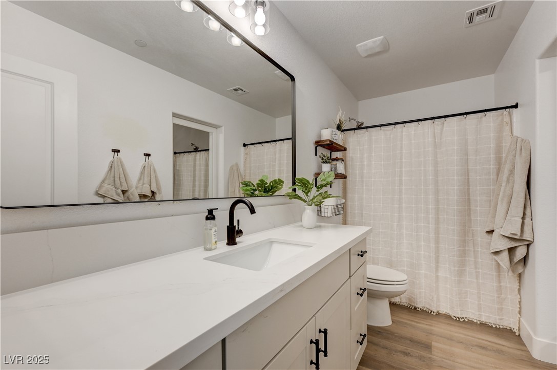 12106 Azure Gate Road, Unit 3 Las Vegas, NV 89183 - Photo 36 of 77 Full bath featuring a shower with shower curtain, vanity, and light wood-style flooring