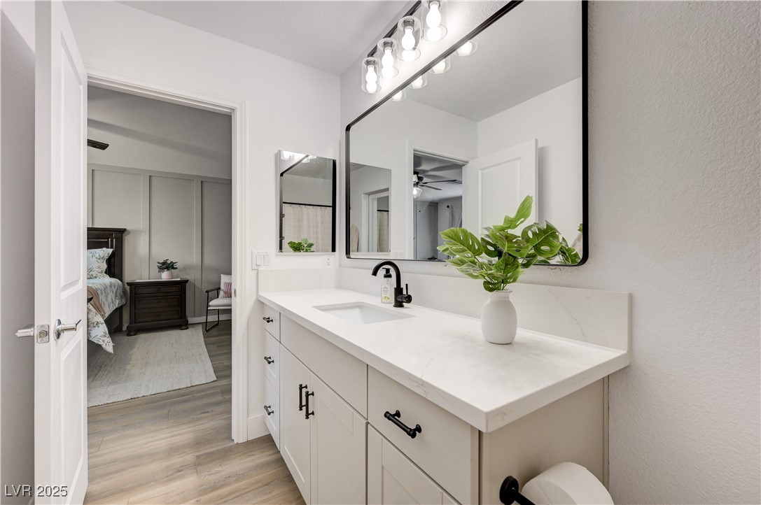 12106 Azure Gate Road, Unit 3 Las Vegas, NV 89183 - Photo 37 of 77 Ensuite bathroom featuring vanity and light wood-style flooring