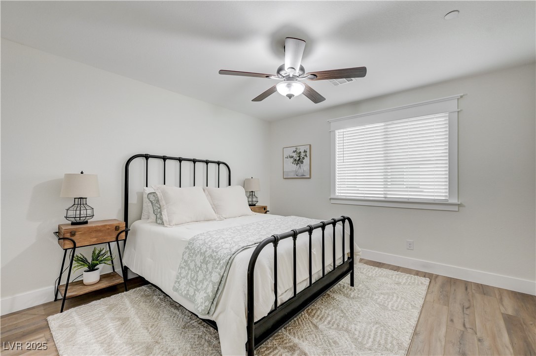 12106 Azure Gate Road, Unit 3 Las Vegas, NV 89183 - Photo 38 of 77 Bedroom with a ceiling fan and light wood-style flooring