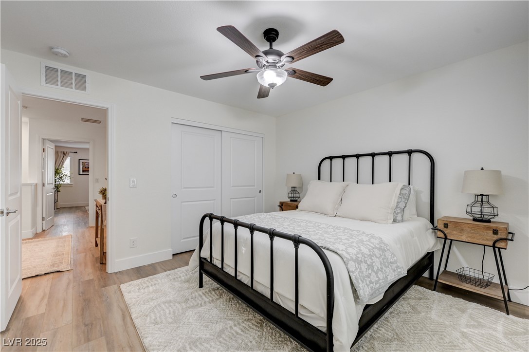 12106 Azure Gate Road, Unit 3 Las Vegas, NV 89183 - Photo 39 of 77 Bedroom with light wood finished floors, ceiling fan, and a closet