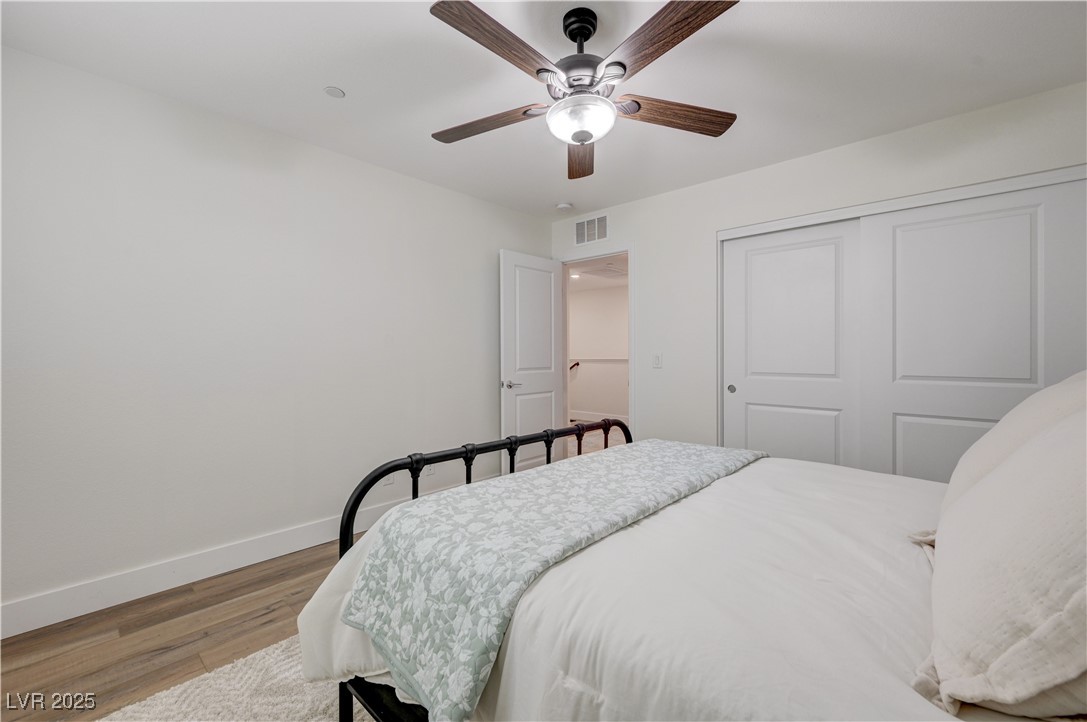 12106 Azure Gate Road, Unit 3 Las Vegas, NV 89183 - Photo 40 of 77 Bedroom with wood finished floors, ceiling fan, and a closet