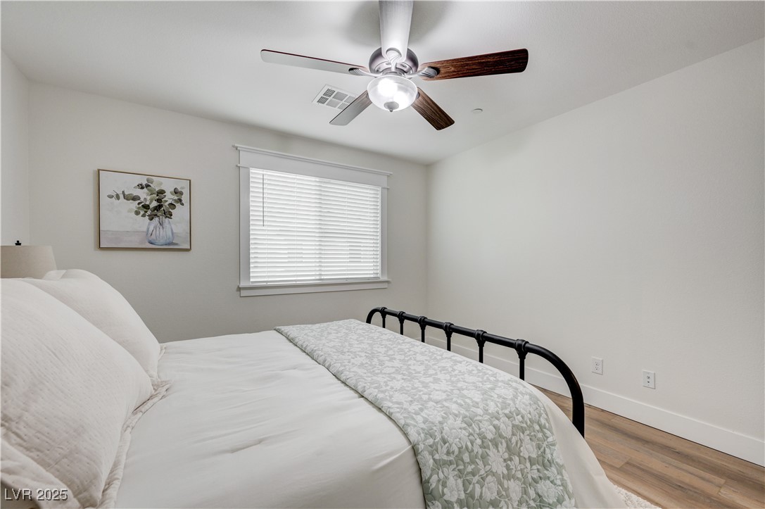 12106 Azure Gate Road, Unit 3 Las Vegas, NV 89183 - Photo 41 of 77 Bedroom with wood finished floors and ceiling fan