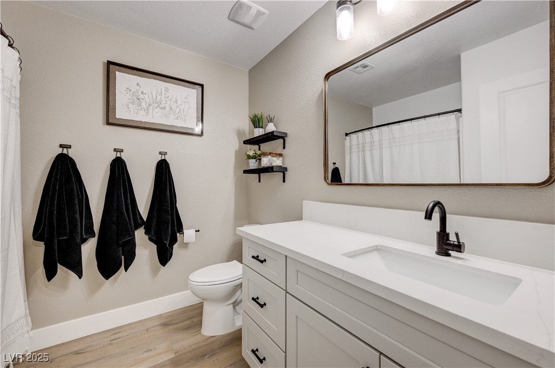 12106 Azure Gate Road, Unit 3 Las Vegas, NV 89183 - Photo 42 of 77 Bathroom with vanity, light wood-style flooring, and a shower with shower curtain