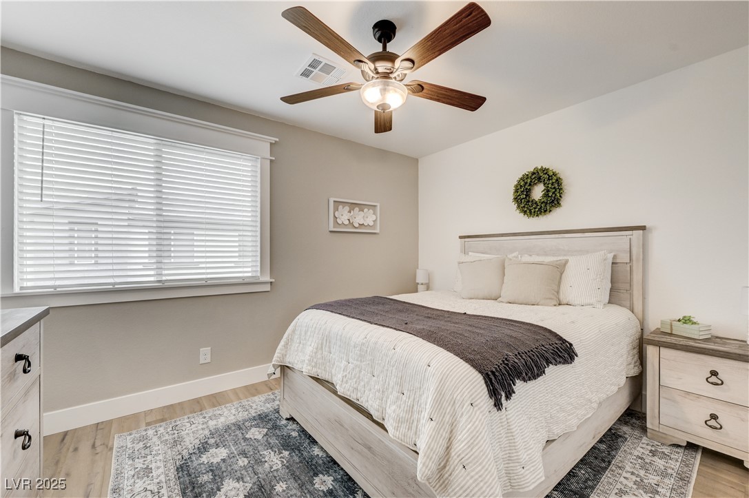 12106 Azure Gate Road, Unit 3 Las Vegas, NV 89183 - Photo 43 of 77 Bedroom featuring light wood finished floors and ceiling fan