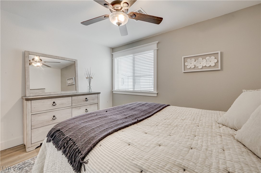 12106 Azure Gate Road, Unit 3 Las Vegas, NV 89183 - Photo 45 of 77 Bedroom featuring light wood-type flooring and a ceiling fan