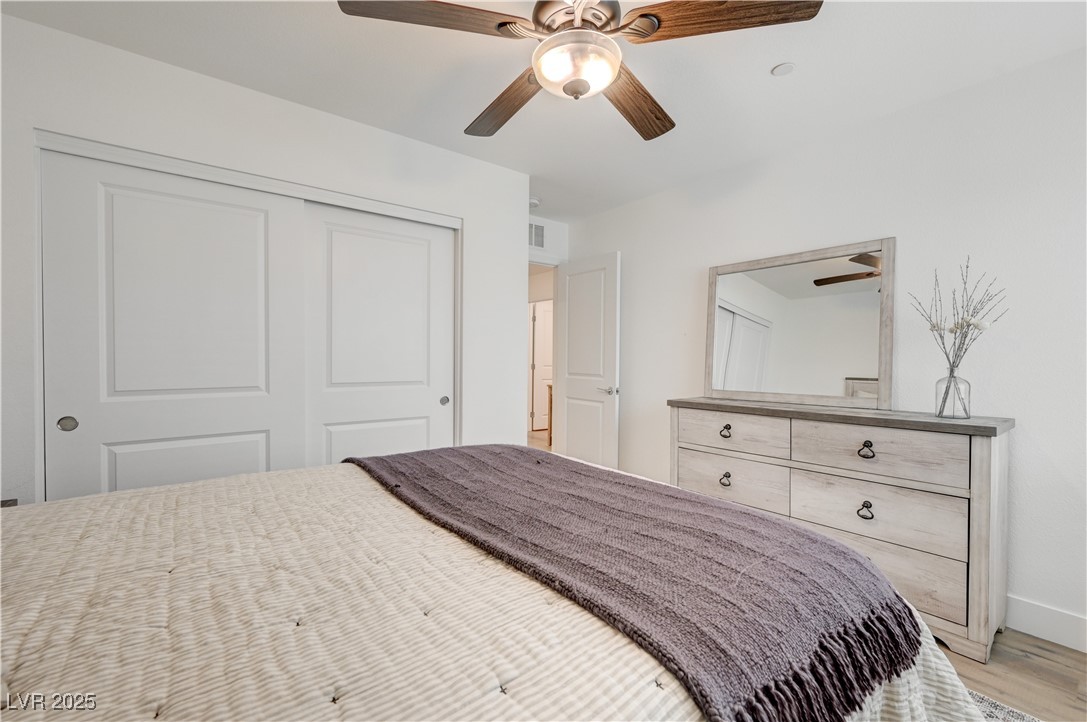 12106 Azure Gate Road, Unit 3 Las Vegas, NV 89183 - Photo 46 of 77 Bedroom with a closet, a ceiling fan, and light wood-style floors