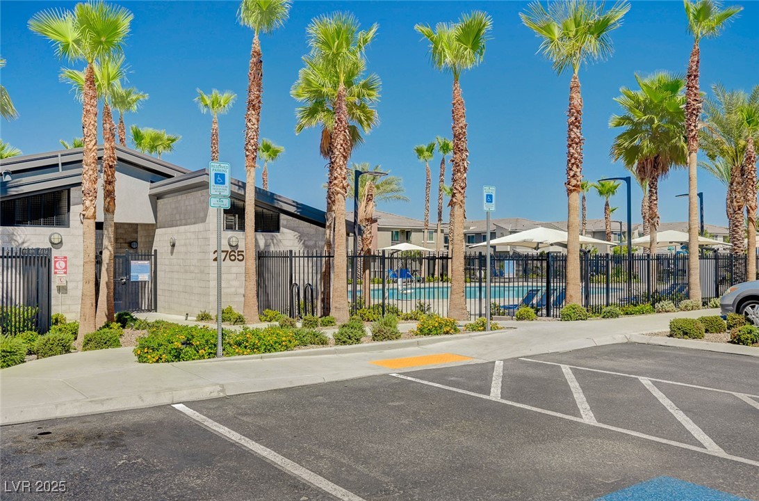 12106 Azure Gate Road, Unit 3 Las Vegas, NV 89183 - Photo 73 of 77 View of building exterior featuring a community pool and uncovered parking