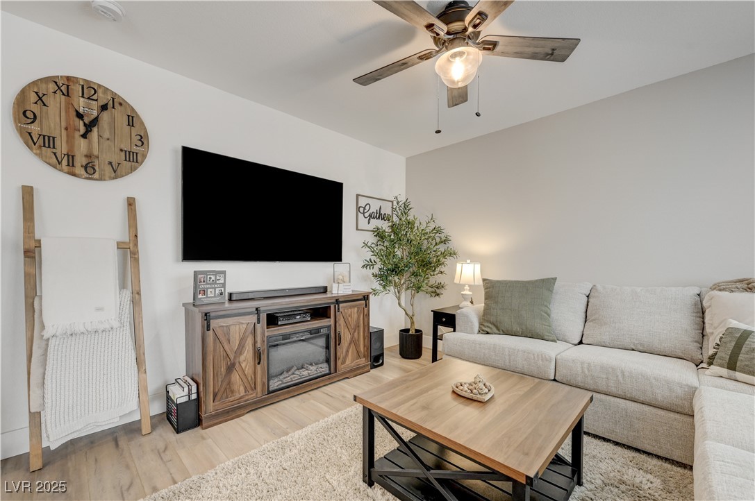 12106 Azure Gate Road, Unit 3 Las Vegas, NV 89183 - Photo 8 of 77 Living area featuring light wood finished floors and ceiling fan