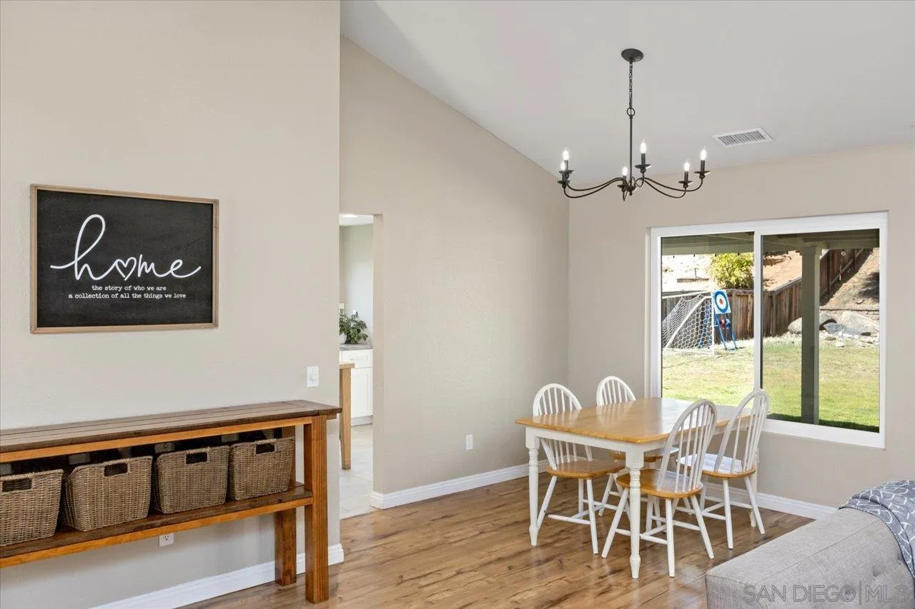 1561 Conway Drive Escondido, CA 92027 - Photo 11 of 41 a view of a dining room with furniture wooden floor and a chandelier