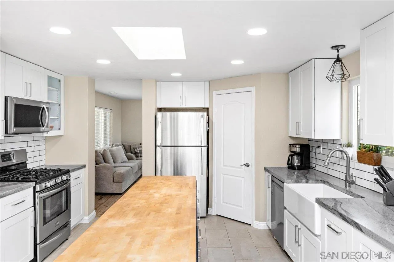1561 Conway Drive Escondido, CA 92027 - Photo 15 of 41 a kitchen with stainless steel appliances a refrigerator sink and microwave
