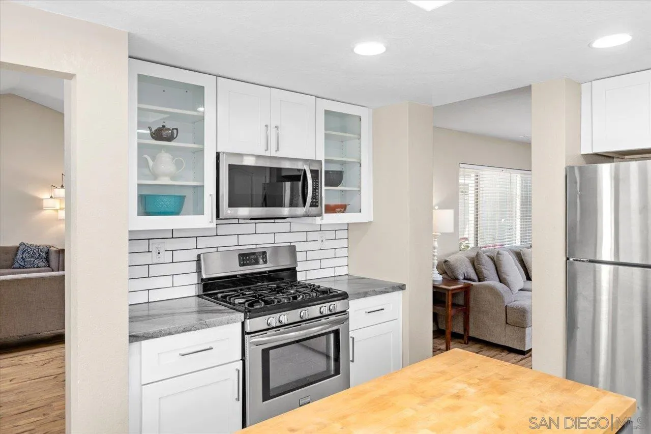 1561 Conway Drive Escondido, CA 92027 - Photo 16 of 41 a kitchen with stainless steel appliances granite countertop a stove a refrigerator and a microwave