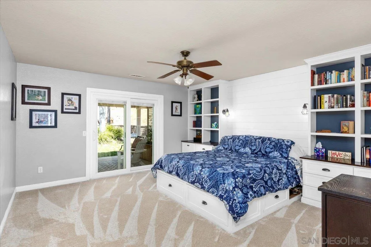1561 Conway Drive Escondido, CA 92027 - Photo 19 of 41 a living room with a bed furniture and a book shelf