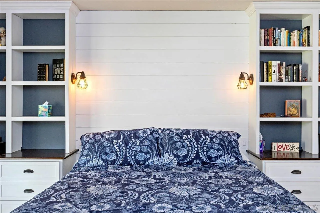 1561 Conway Drive Escondido, CA 92027 - Photo 22 of 41 a bed sitting in a bedroom next to a book shelf