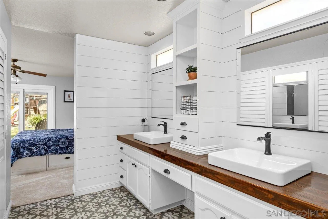 1561 Conway Drive Escondido, CA 92027 - Photo 24 of 41 a bathroom with a double vanity sink and mirror