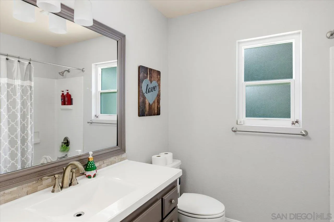 1561 Conway Drive Escondido, CA 92027 - Photo 28 of 41 a bathroom with a sink vanity mirror and toilet