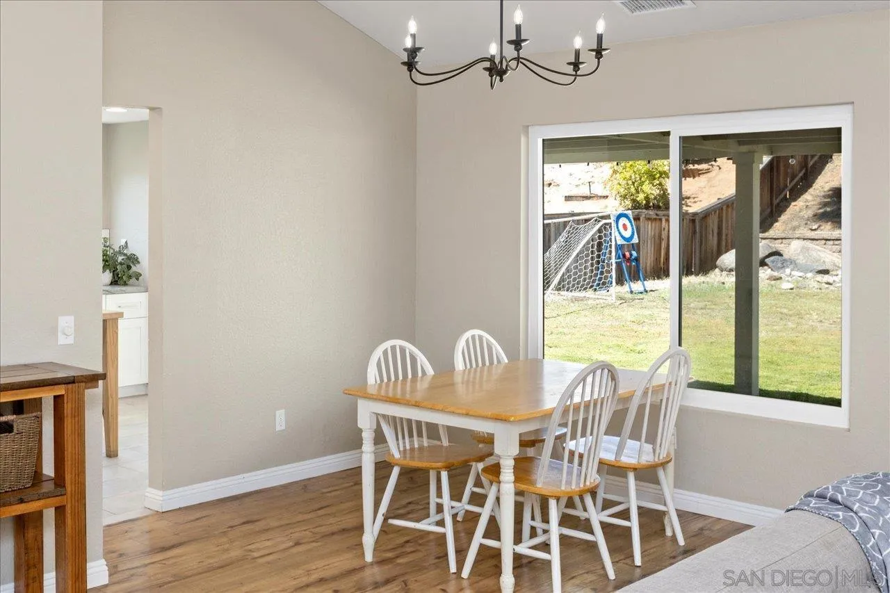 1561 Conway Drive Escondido, CA 92027 - Photo 10 of 41 a view of a dining room with furniture wooden floor and a chandelier