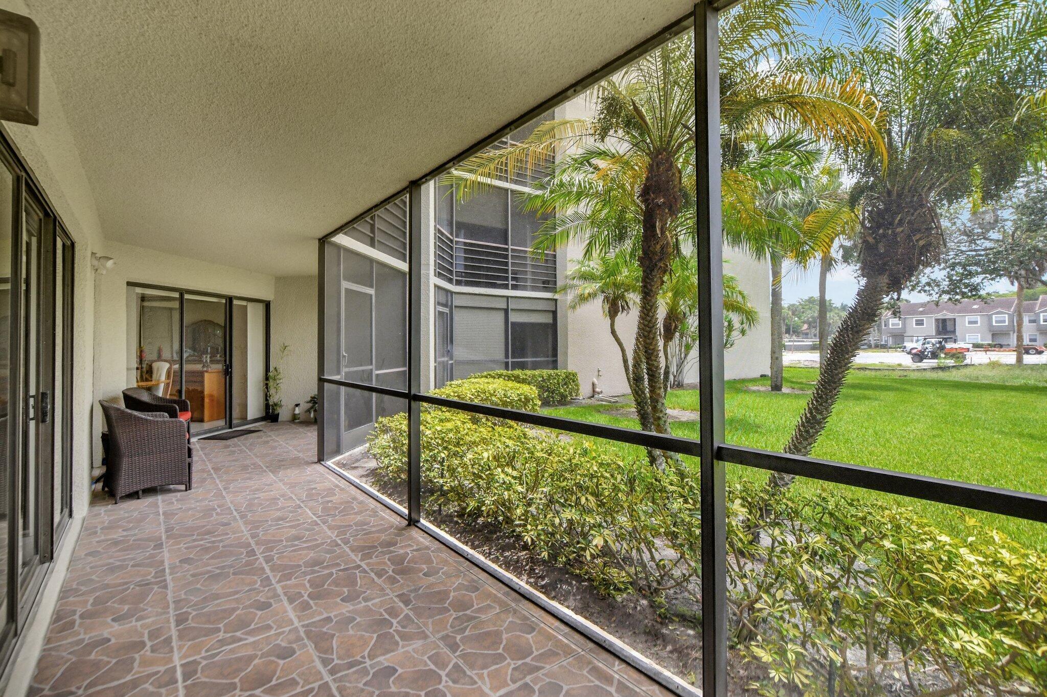 5901 Camino Del Sol, Unit 107 Boca Raton, FL 33433 - Photo 16 of 51 a view of balcony with a garden