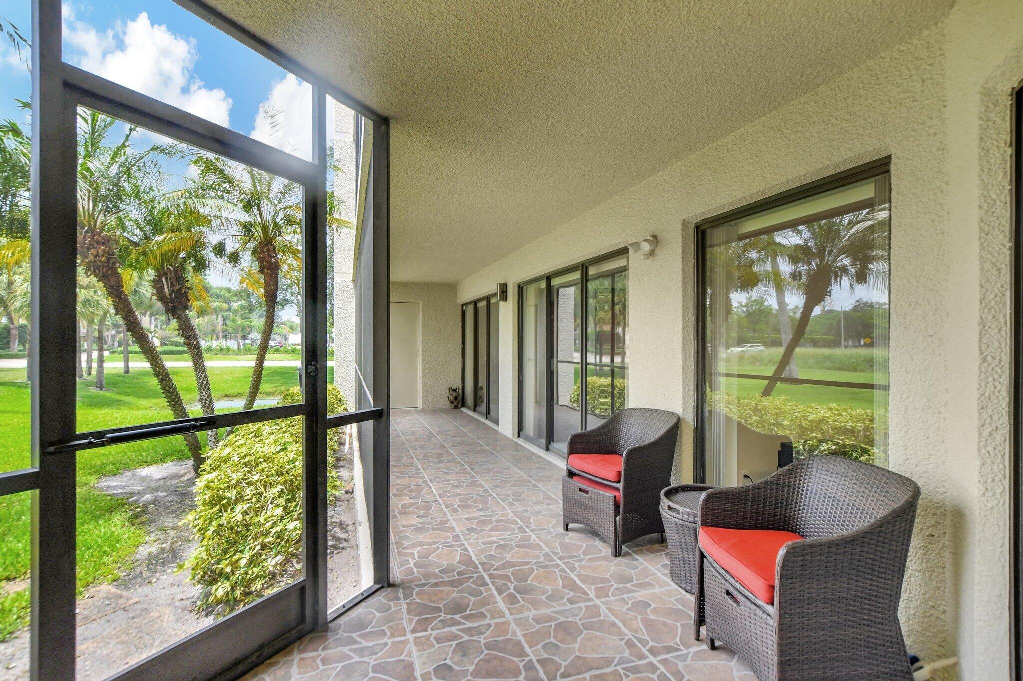 5901 Camino Del Sol, Unit 107 Boca Raton, FL 33433 - Photo 17 of 51 a room with furniture and large windows