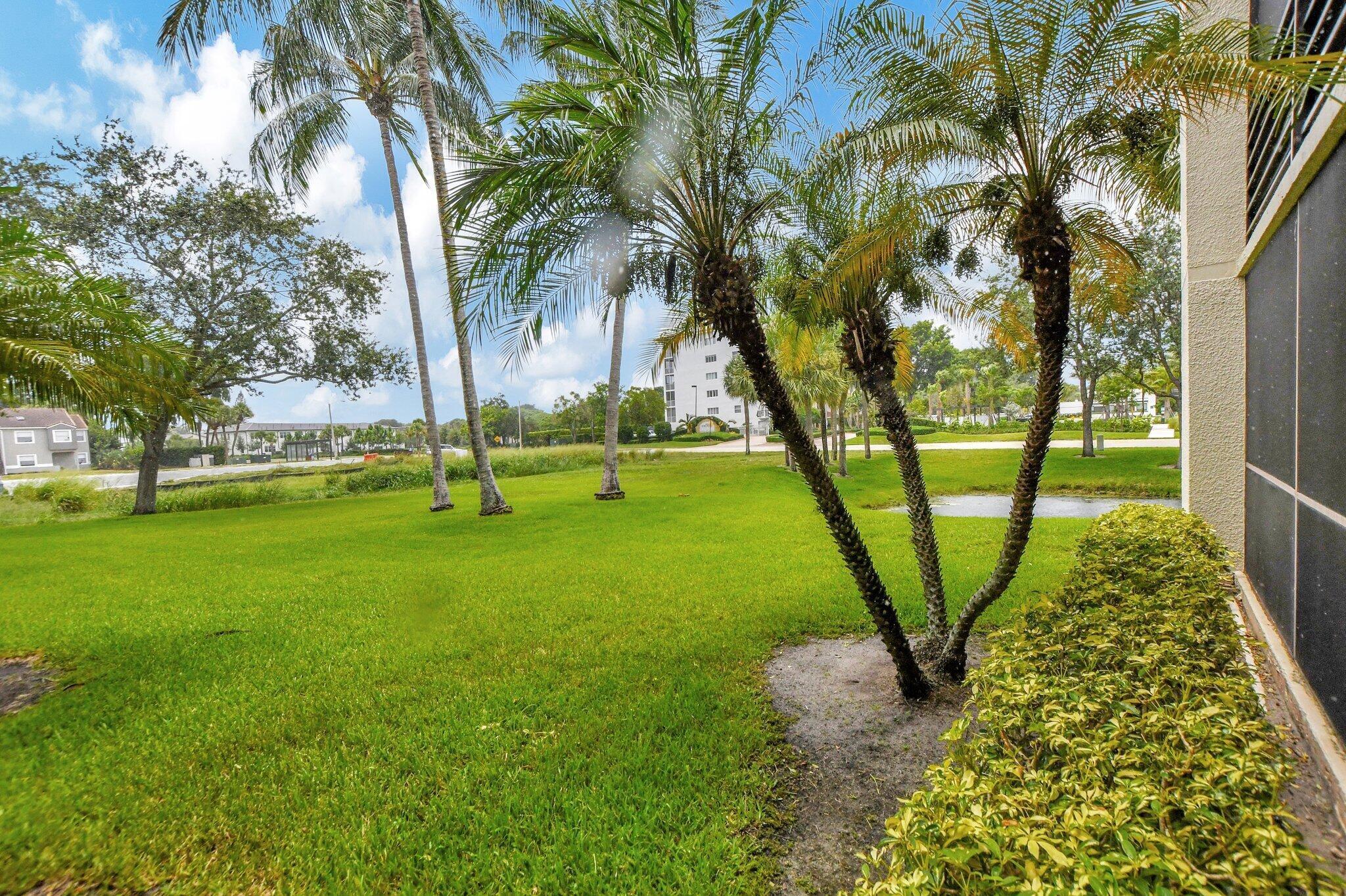 5901 Camino Del Sol, Unit 107 Boca Raton, FL 33433 - Photo 19 of 51 a view of a park with large trees