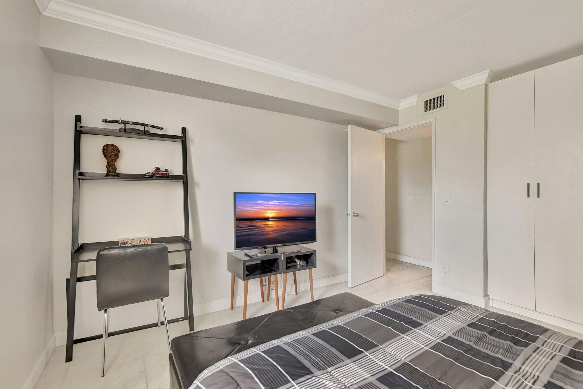 5901 Camino Del Sol, Unit 107 Boca Raton, FL 33433 - Photo 21 of 51 a living room with furniture and a flat screen tv