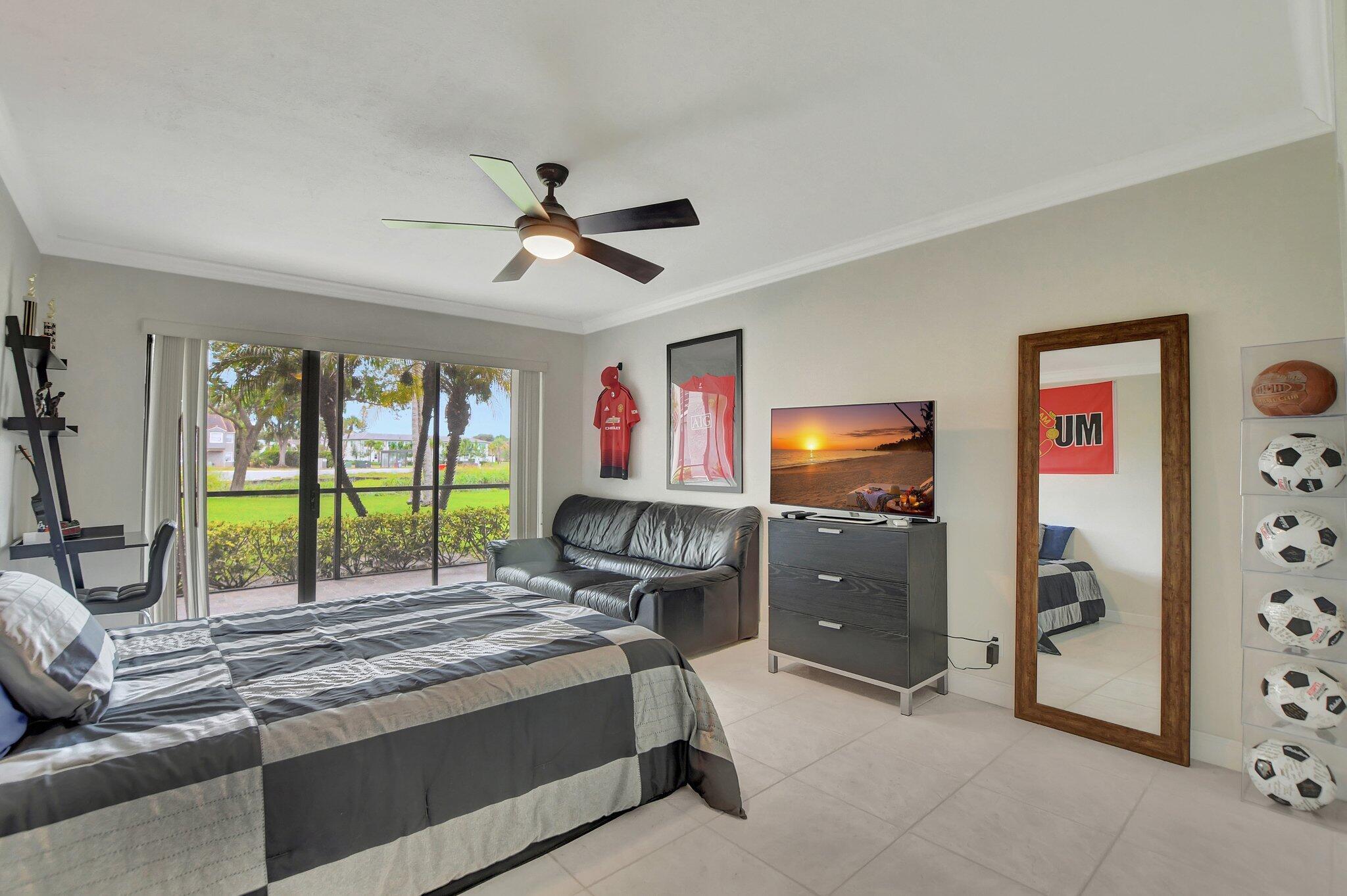 5901 Camino Del Sol, Unit 107 Boca Raton, FL 33433 - Photo 25 of 51 a living room with furniture and a flat screen tv