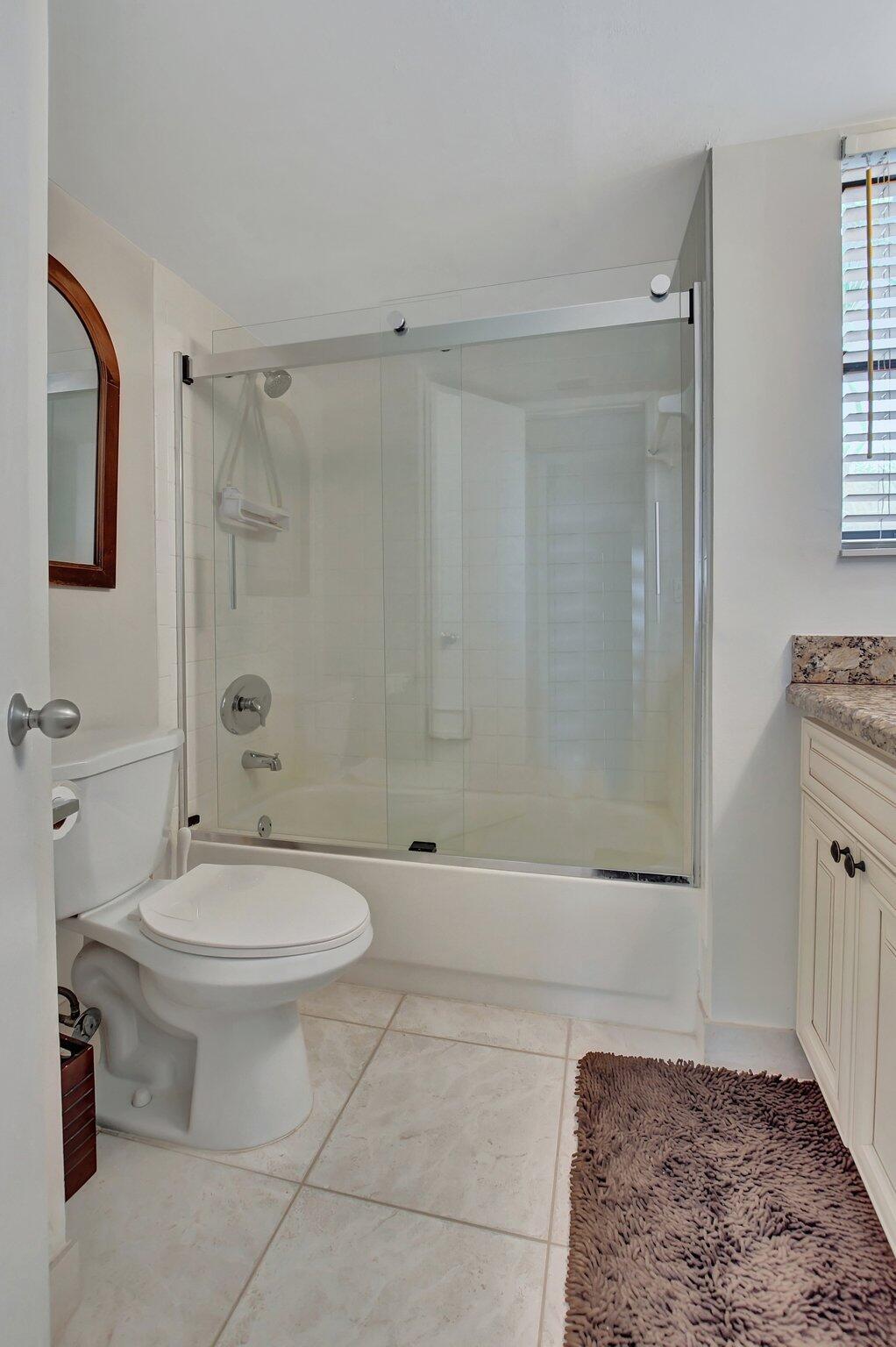 5901 Camino Del Sol, Unit 107 Boca Raton, FL 33433 - Photo 28 of 51 a bathroom with a sink a toilet and shower
