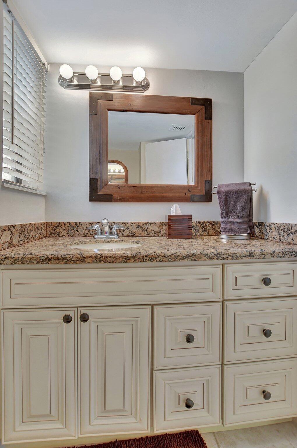 5901 Camino Del Sol, Unit 107 Boca Raton, FL 33433 - Photo 29 of 51 a bathroom with sink granite and mirror