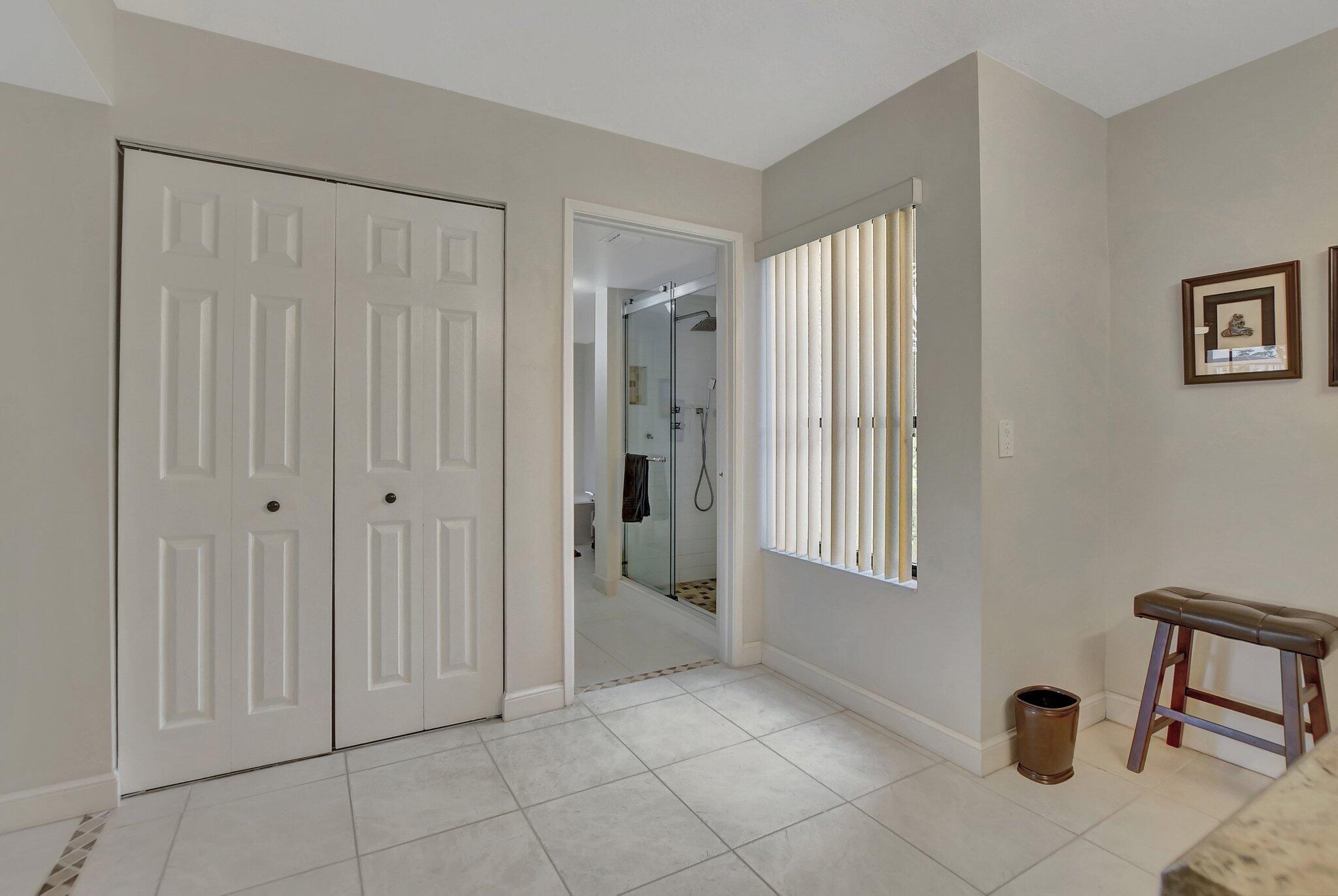 5901 Camino Del Sol, Unit 107 Boca Raton, FL 33433 - Photo 30 of 51 a view of an empty room with window and bathroom