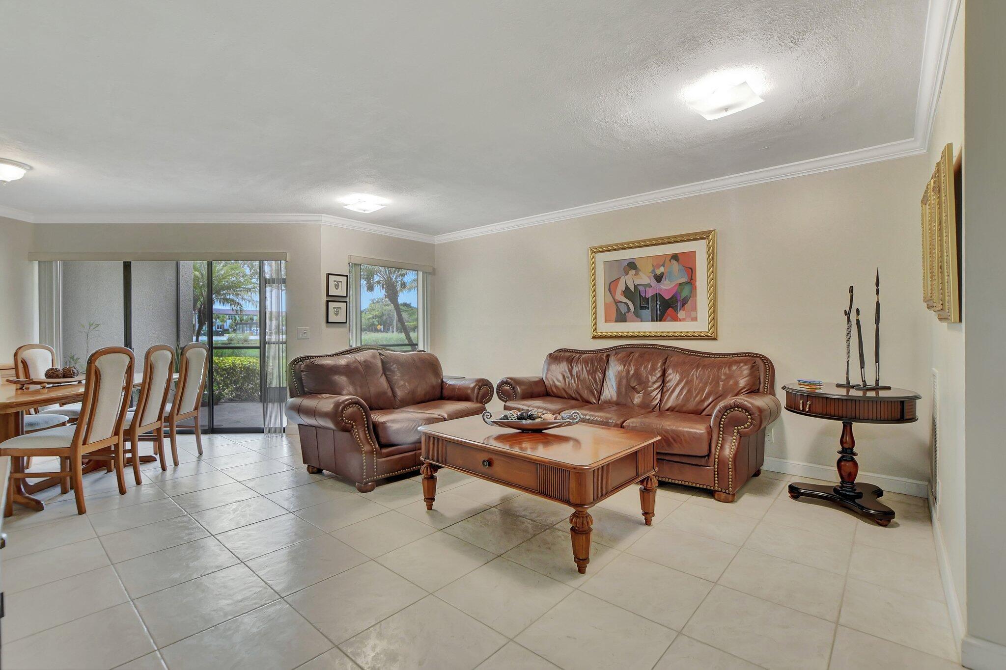 5901 Camino Del Sol, Unit 107 Boca Raton, FL 33433 - Photo 4 of 51 a living room with furniture and a large window