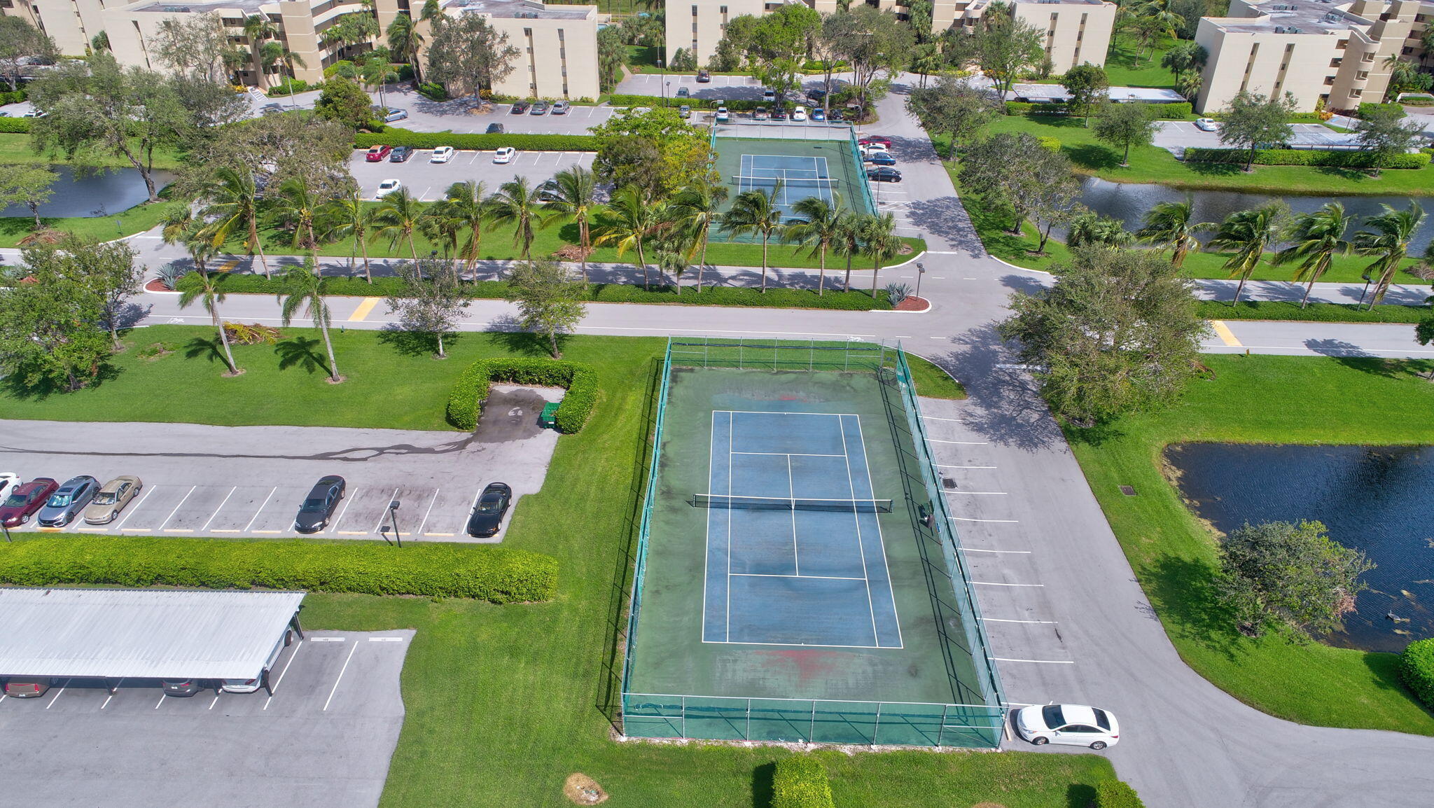 5901 Camino Del Sol, Unit 107 Boca Raton, FL 33433 - Photo 43 of 51 an aerial view of a house with a garden and lake view