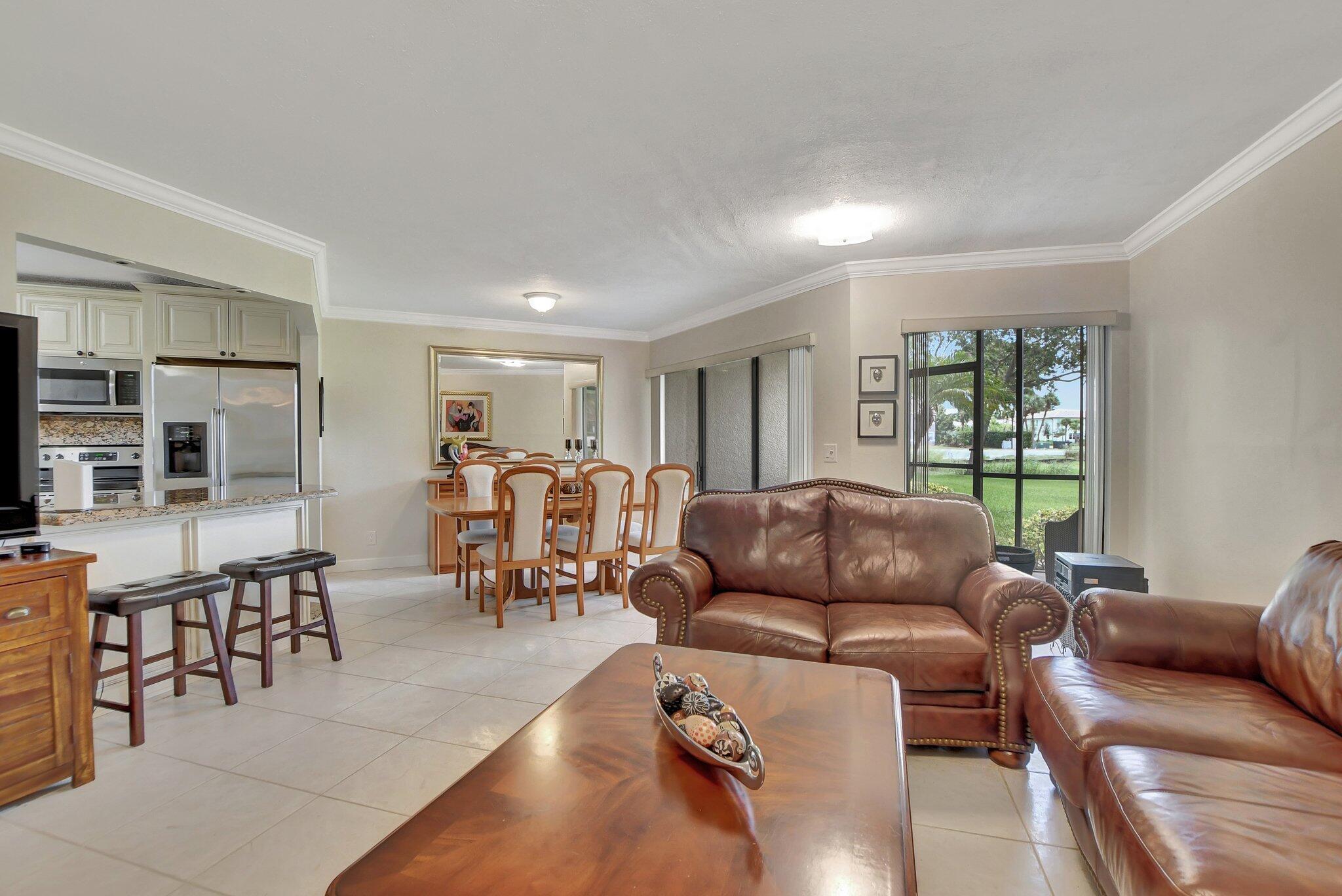 5901 Camino Del Sol, Unit 107 Boca Raton, FL 33433 - Photo 6 of 51 a living room with furniture and a window