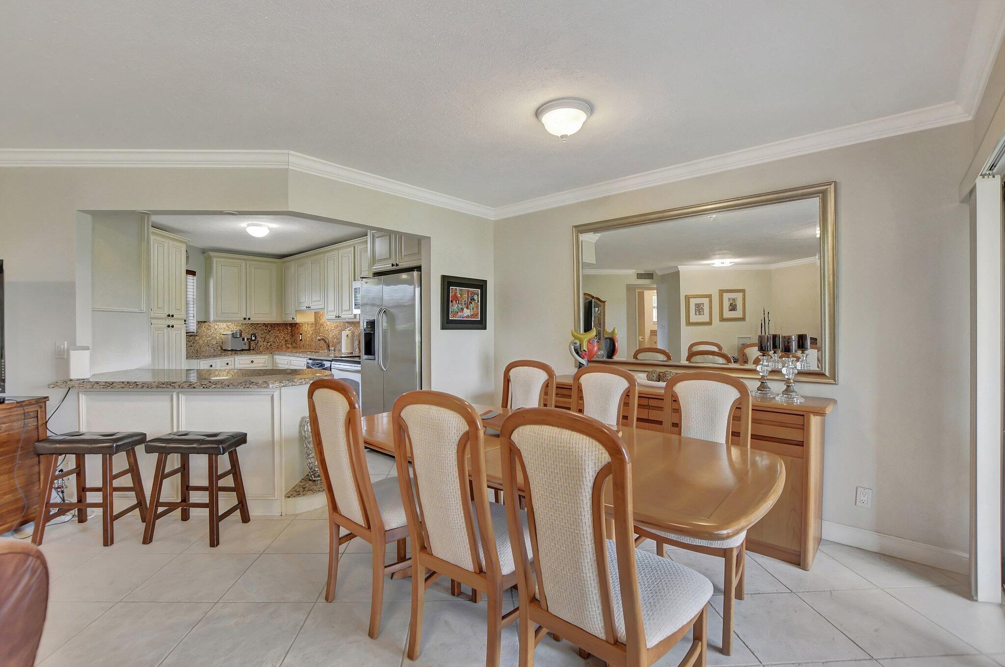 5901 Camino Del Sol, Unit 107 Boca Raton, FL 33433 - Photo 9 of 51 a dining room with furniture and window