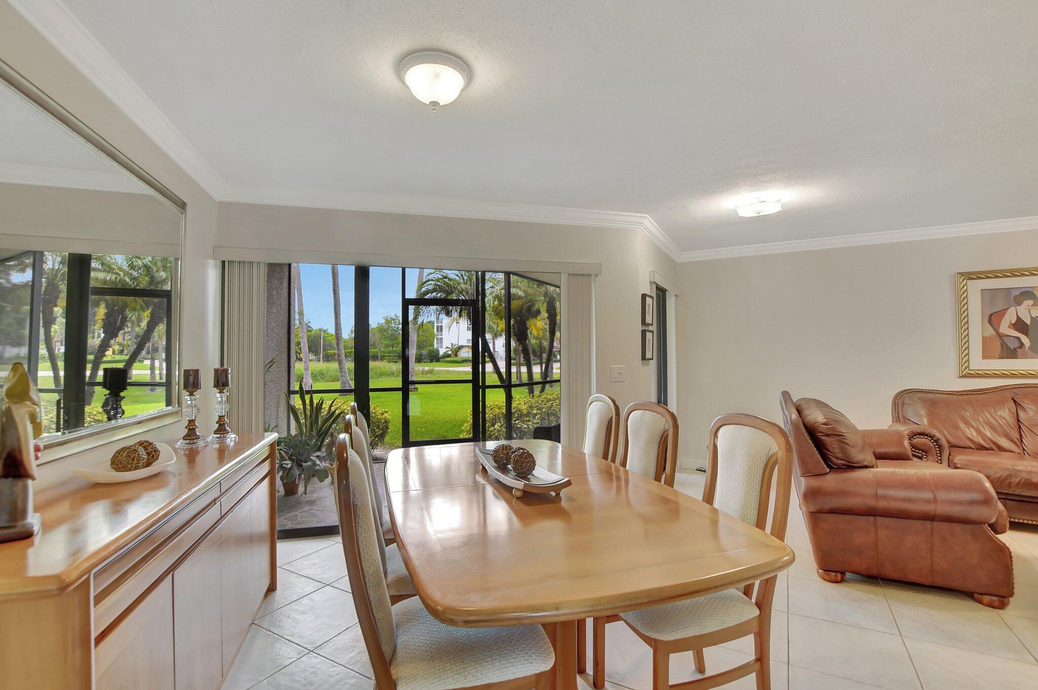 5901 Camino Del Sol, Unit 107 Boca Raton, FL 33433 - Photo 10 of 51 a living room with furniture and a large window