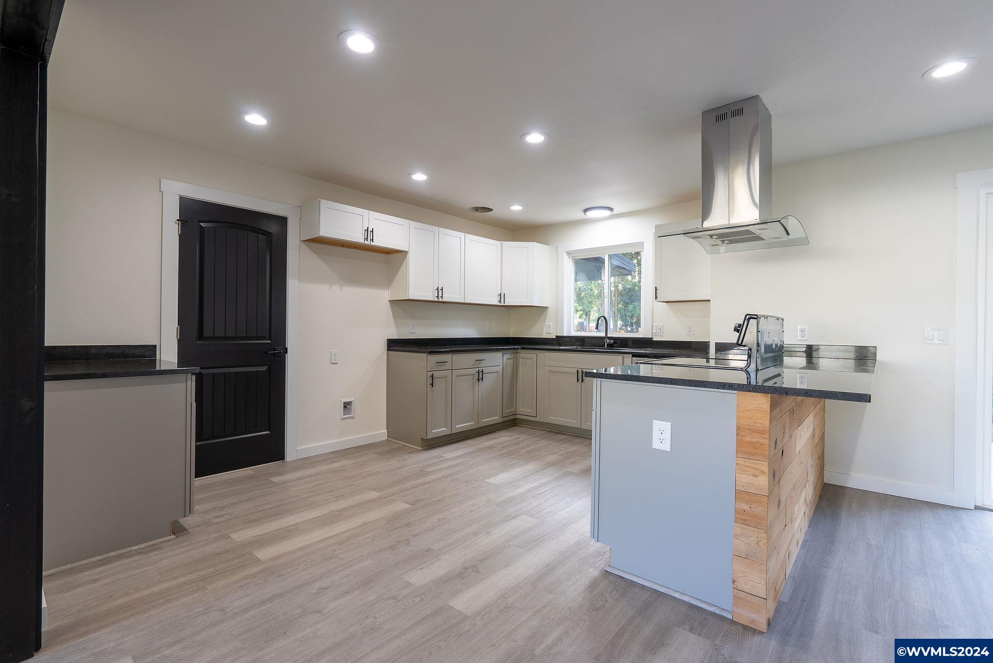5085 Windsor Island Road North Keizer, OR 97303 - Photo 10 of 22 a kitchen with stainless steel appliances granite countertop a refrigerator a sink dishwasher a stove and white countertops with wooden floor